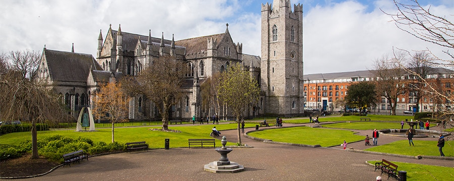 Four elderly women sit on a park bench in front of a large old castle in Dublin Ireland Four elderly women sit on a park bench in front of a large old castle in Dublin Ireland