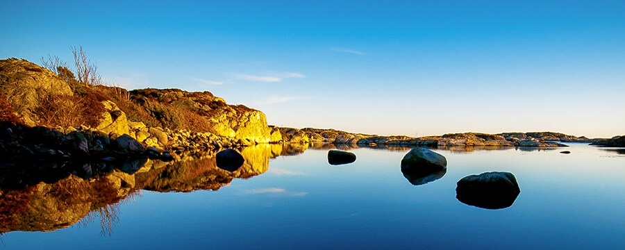 Stony coast line surrounds a placid body of water