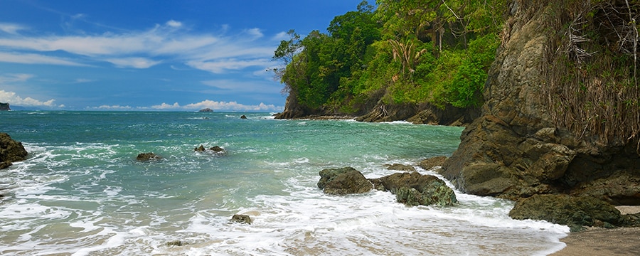 The shoreline of Manuel Antonio National Park on Costa Rica’s central Pacific Coast reveals rugged rainforest and a sandy beach The shoreline of Manuel Antonio National Park on Costa Rica’s central Pacific Coast reveals rugged rainforest and a sandy beach