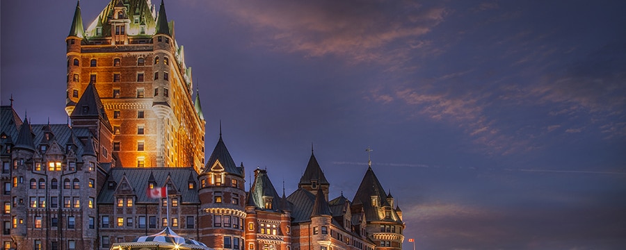 A brickwork hotel surrounded by streetlights and a Canadian flag A brickwork hotel surrounded by streetlights and a Canadian flag