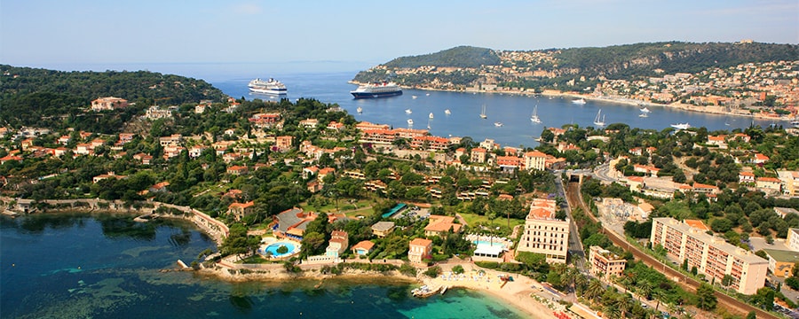Two tropical peninsulas populated by builidings surround a bay Two tropical peninsulas populated by builidings surround a bay