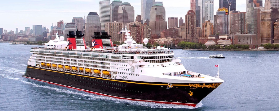 A Disney cruise ship sails in front of the New York City skyline A Disney cruise ship sails in front of the New York City skyline