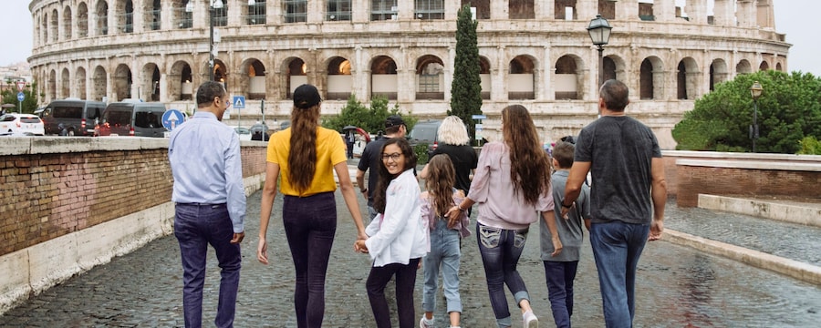 A group of 10 people walk toward the Colosseum in Rome, Italy A group of 10 people walk toward the Colosseum in Rome, Italy