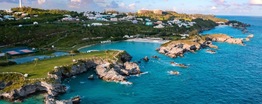A coastal inlet beside a hill with a lighthouse in Bermuda A coastal inlet beside a hill with a lighthouse in Bermuda