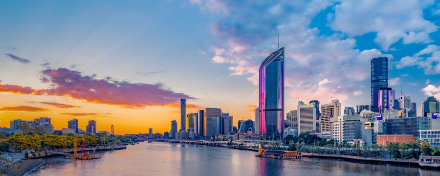 The Brisbane skyline features a river running through a city with tall buildings