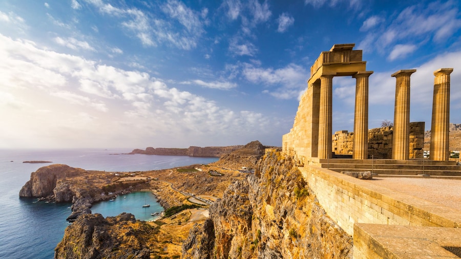 Ancient ruins on a cliff overlooking the ocean with boats in the bay of Rhodes, Greece Ancient ruins on a cliff overlooking the ocean with boats in the bay of Rhodes, Greece