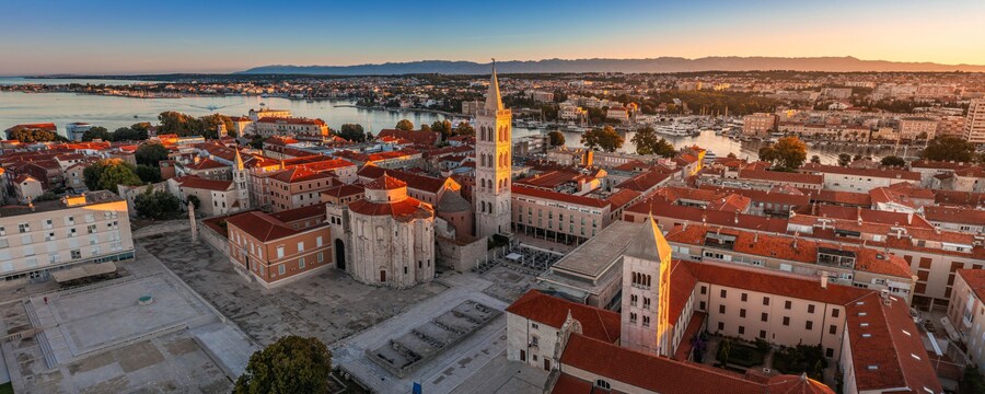 Zadar’s Roman Forum with Saint Donatus Church and Saint Anastasia Cathedral bell tower at sunset