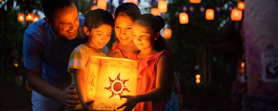 A family gathered around a glowing luminaria