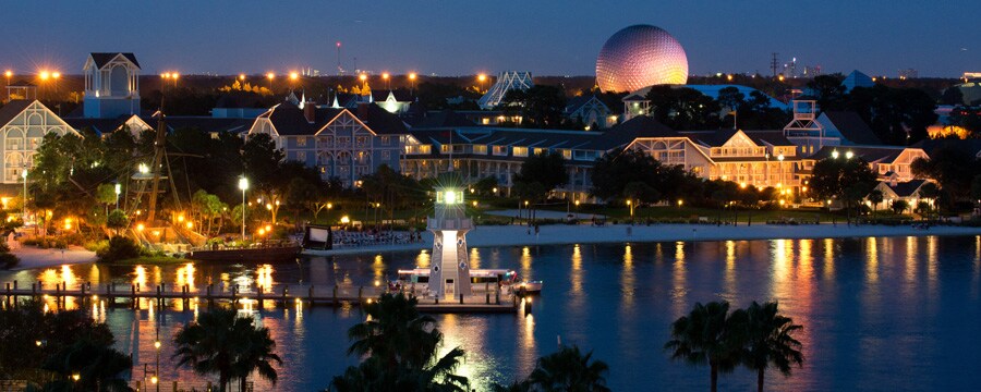 A nighttime view of Disney's Beach Club Resort from Crescent Lake