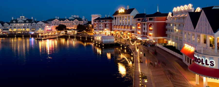 Panoramic view of Disney's BoardWalk Inn and Crescent Lake, lit up at night