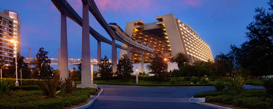 The monorail entering the main concourse of Disney's Contemporary Resort at sunset