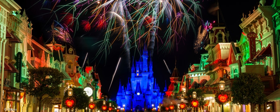 Dazzling fireworks over Cinderella Castle framed by Main Street U.S.A. lit up at night