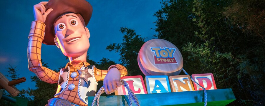 The entrance to Toy Story Land, featuring a giant Woody figure and oversized toys