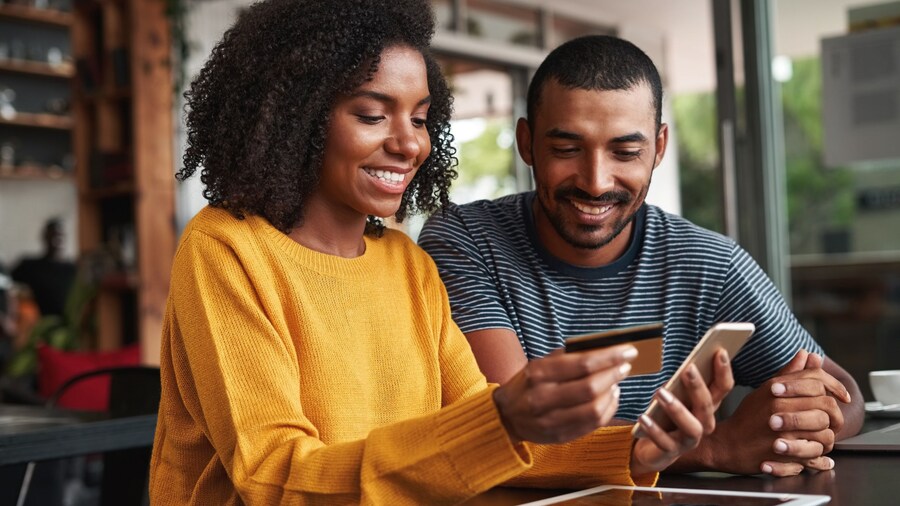 Couple Paying Their Holiday by Mobile Phone