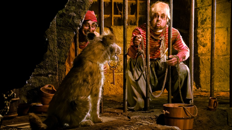 Two jailed pirates beg a dog to bring them their cell key on the Pirates of the Caribbean attraction