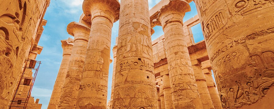 The intricately decorated columns of the Karnak Temple in Luxor, Egypt.