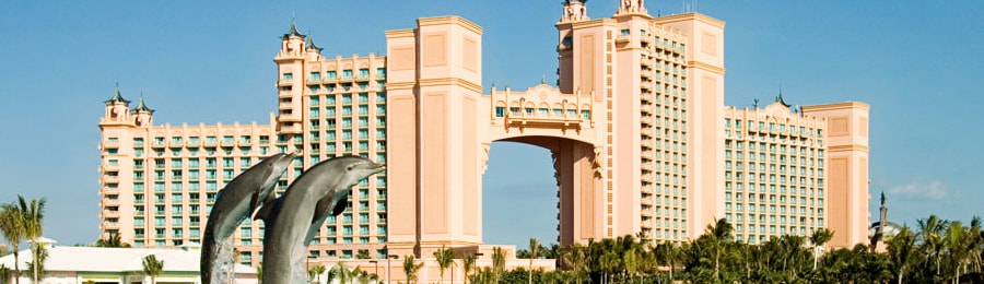 Two dolphins jumping in front of Atlantis Resort in the Bahamas