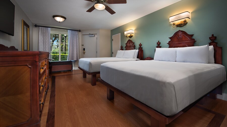 A hotel room with 2 queen size beds and a window with a view