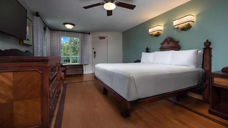 A hotel room with 1 king size bed and a window with a view