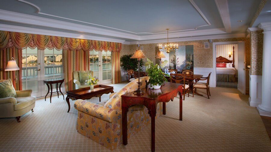 Formal living room with crown moldings, draperies with valances and Victorian-inspired furnishings