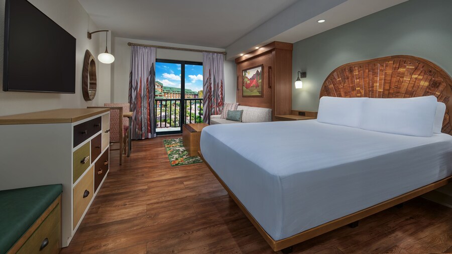 A hotel room featuring a bed, couch and courtyard views