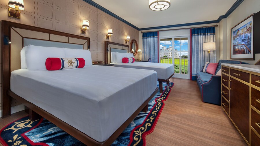 A Disney´s Yacht Club Resort View Room with 2 beds, a sofa, a dresser and a patio