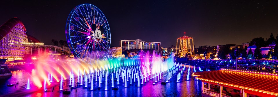 Joy from Inside Out illuminated on the spray from fountains during the World of Color Happiness nighttime show