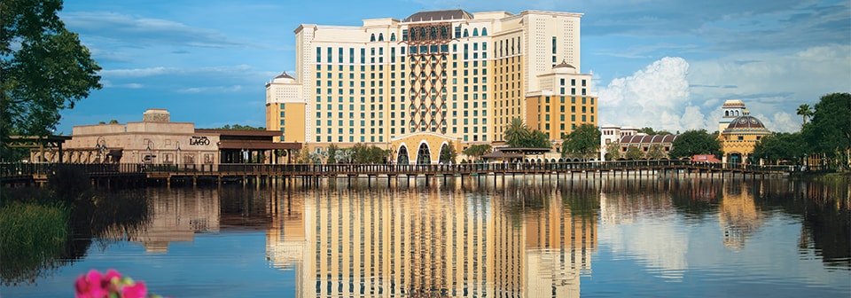 The Gran Destino Tower at Disney’s Coronado Springs Resort, adjacent to the waterfront restaurant Villa del Lago, is reflected on the nearby lake