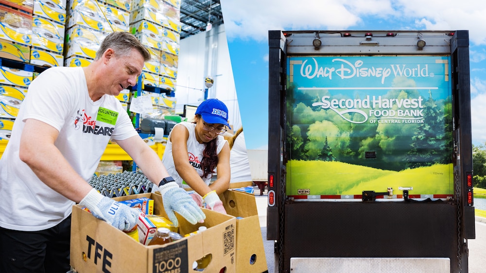 Two Disney Voluntears sorting through boxes of food at Second Harvest Food Bank of Central Florida 