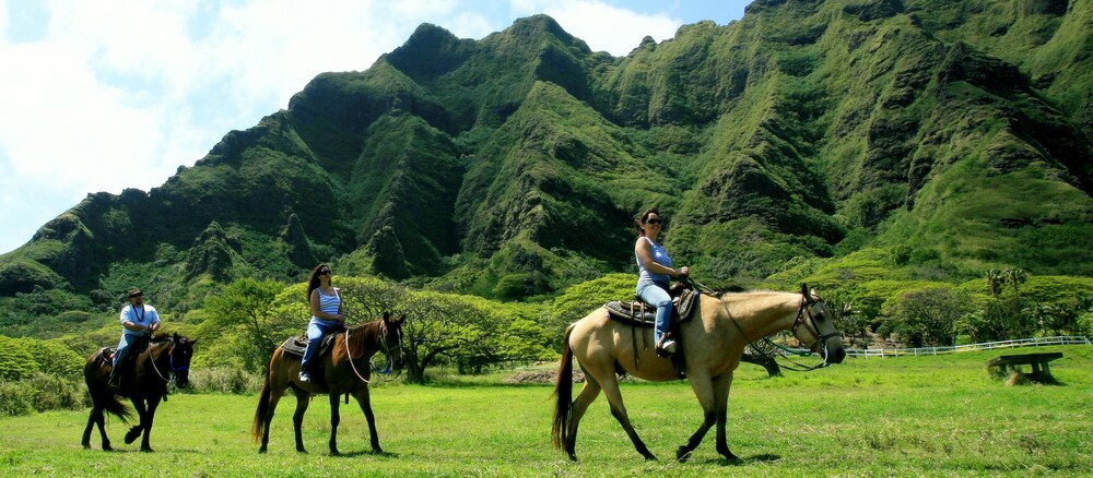 Kualoa Ranch Private Beach And Horseback Tour Aulani Hawaii Resort Two Women Riding Horses Through A Lush Hawaiian Valley