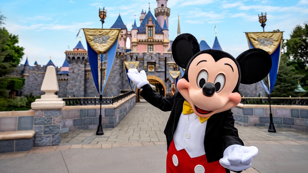 Mickey, in front of the bridge leading to Sleeping Beauty Castle, welcomes you to Disneyland Park