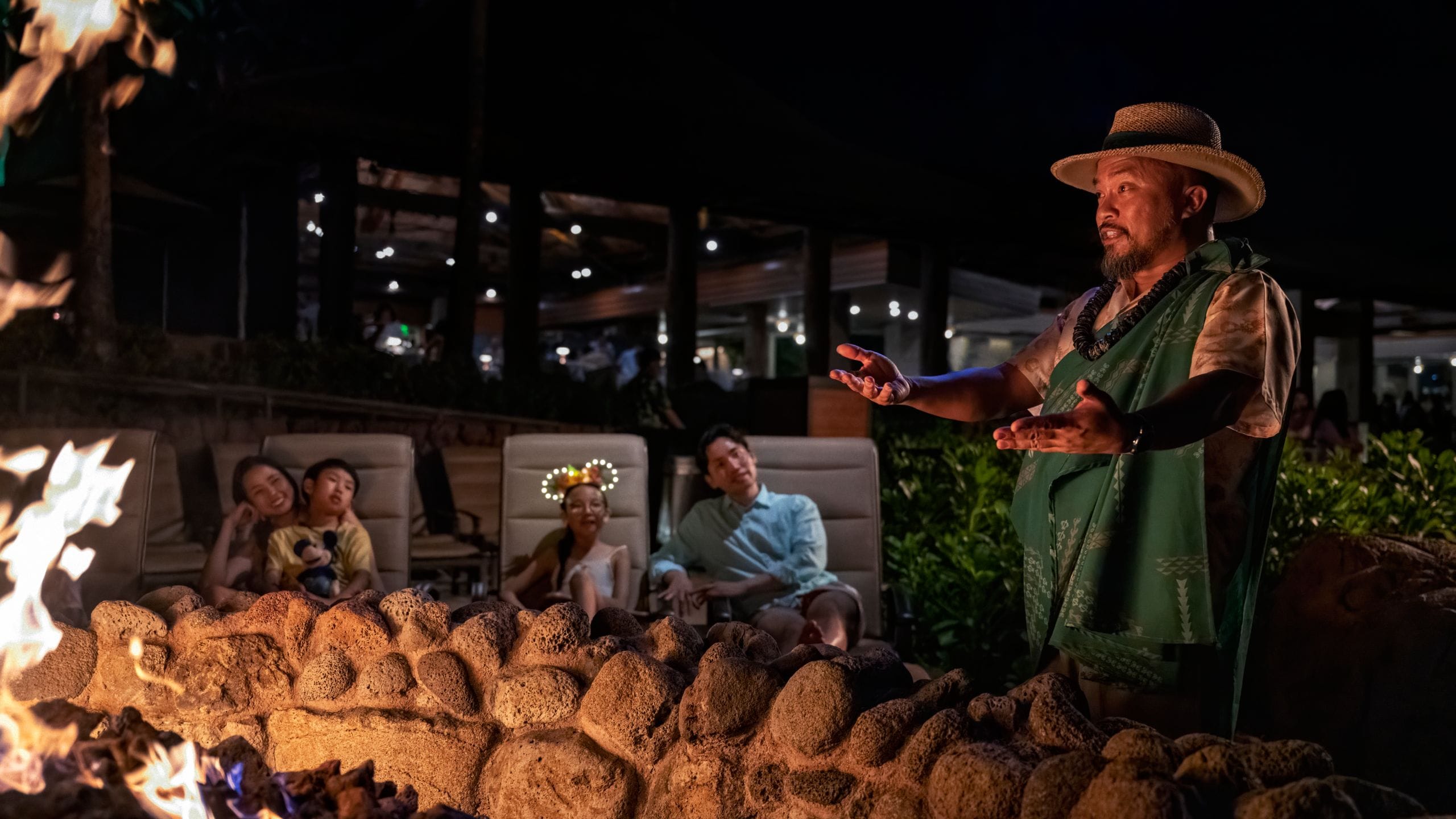 Uncle, a cultural guide, telling a story during Fireside Moʻolelo at Aulani, a Disney Resort & Spa