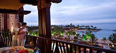 A couple peers over the balcony at Ko Olina Beach