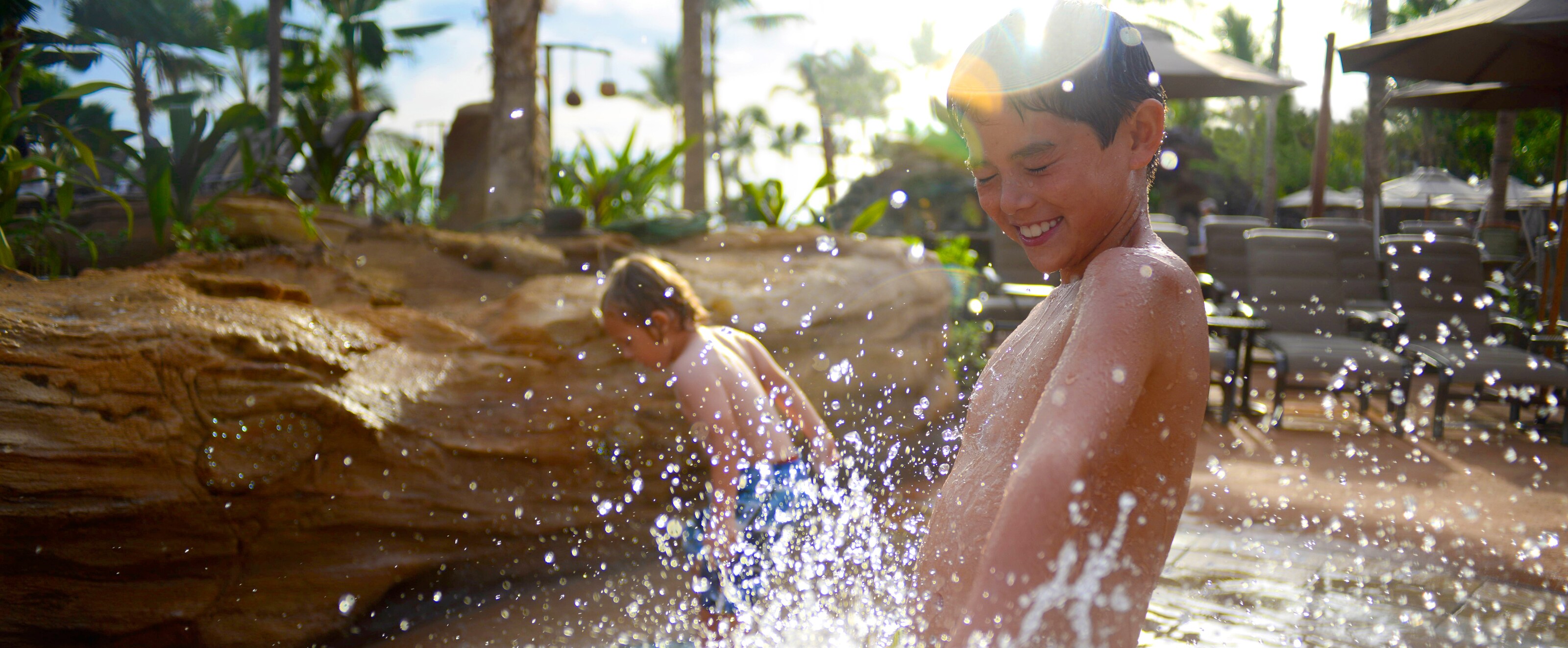 Two young boys enjoy the splash zone