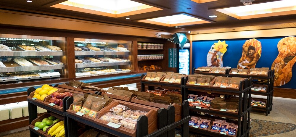 Inside the Ulu Cafe store, with rows of pastries, fruit, juice and chips