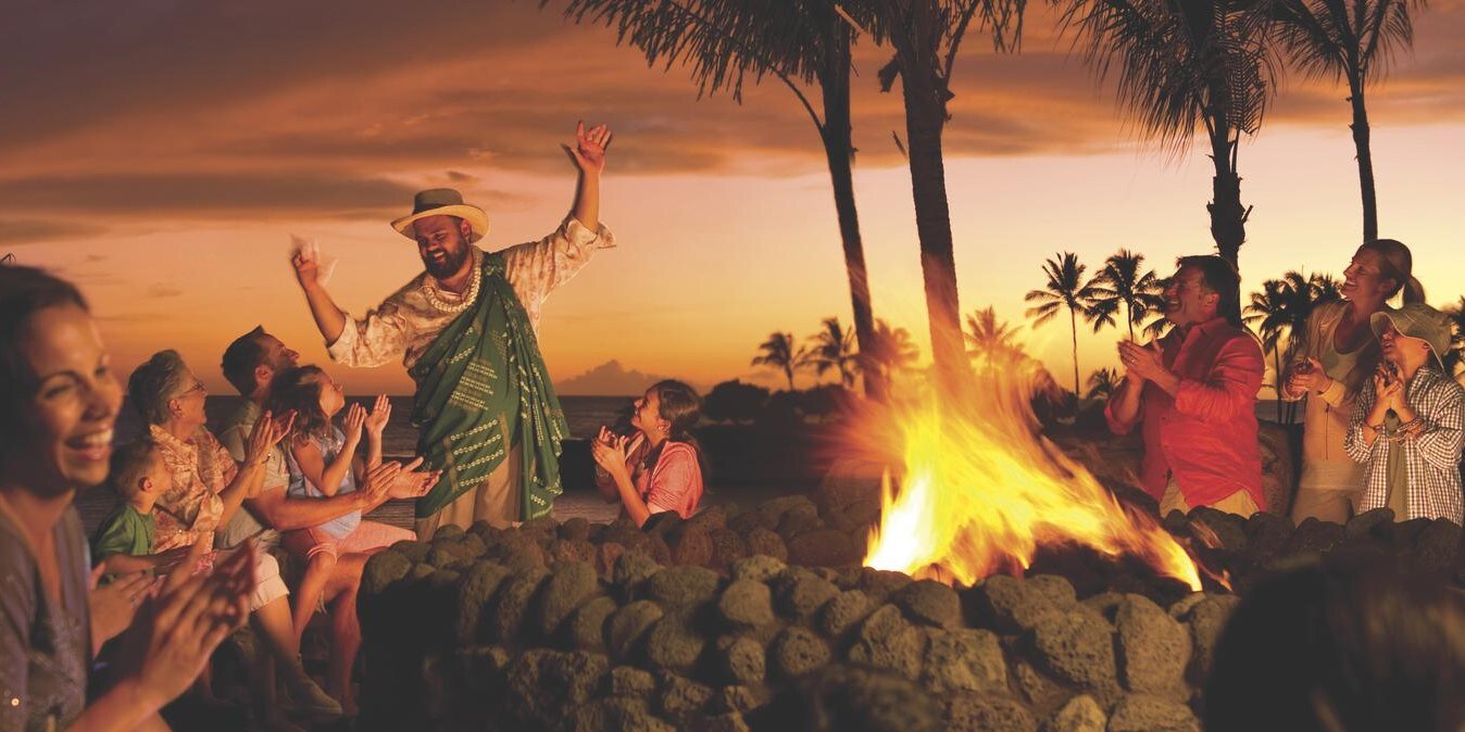 Several people gathered around a fire pit to listen to a storyteller