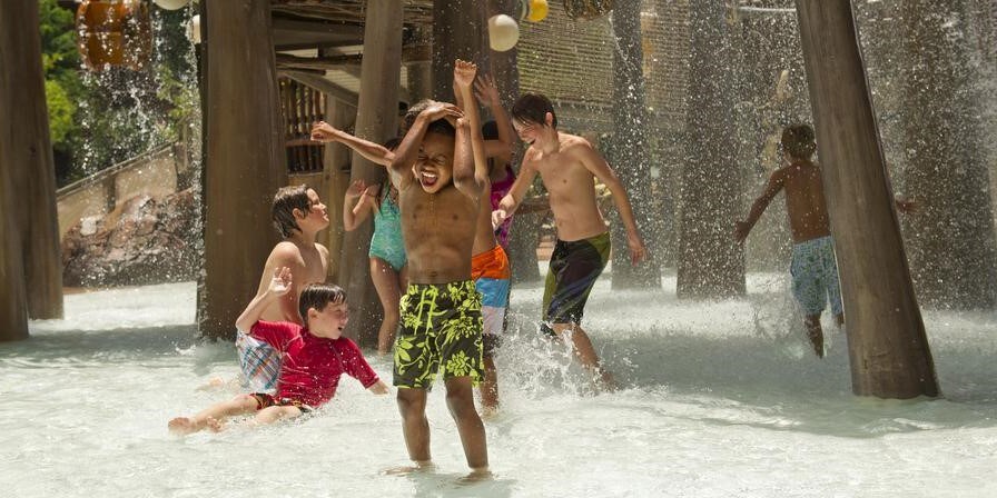 Several children playing in a water playground