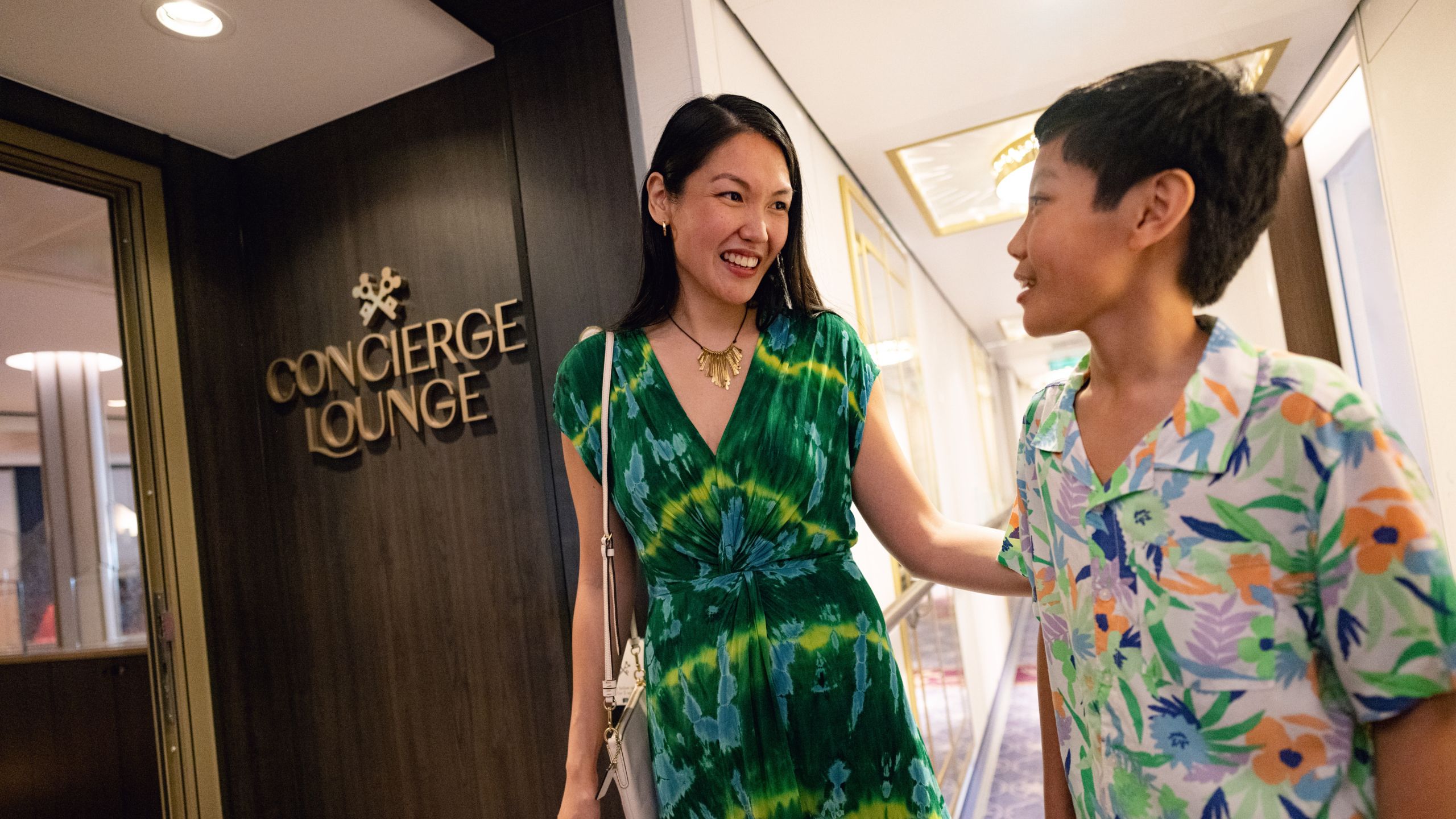 A mother and her son at the Concierge Lounge of a Disney Cruise Line ship