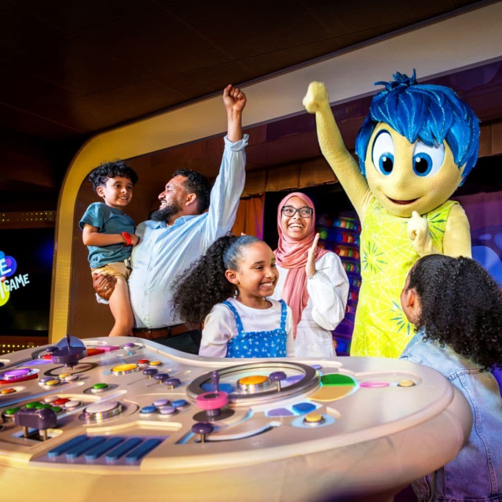 A family playing the Inside Out game with Joy at D Lounge on board the Disney Dream ship