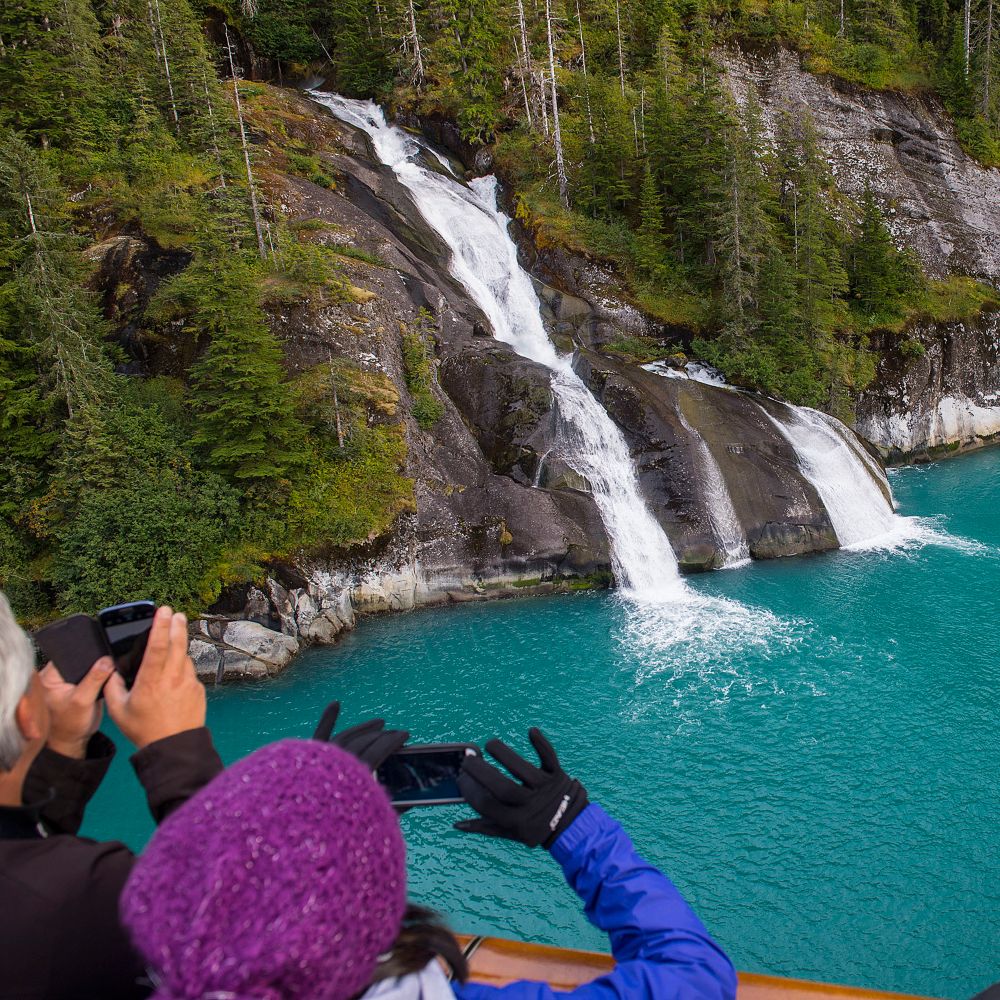 Guests taking photos of a waterfall
