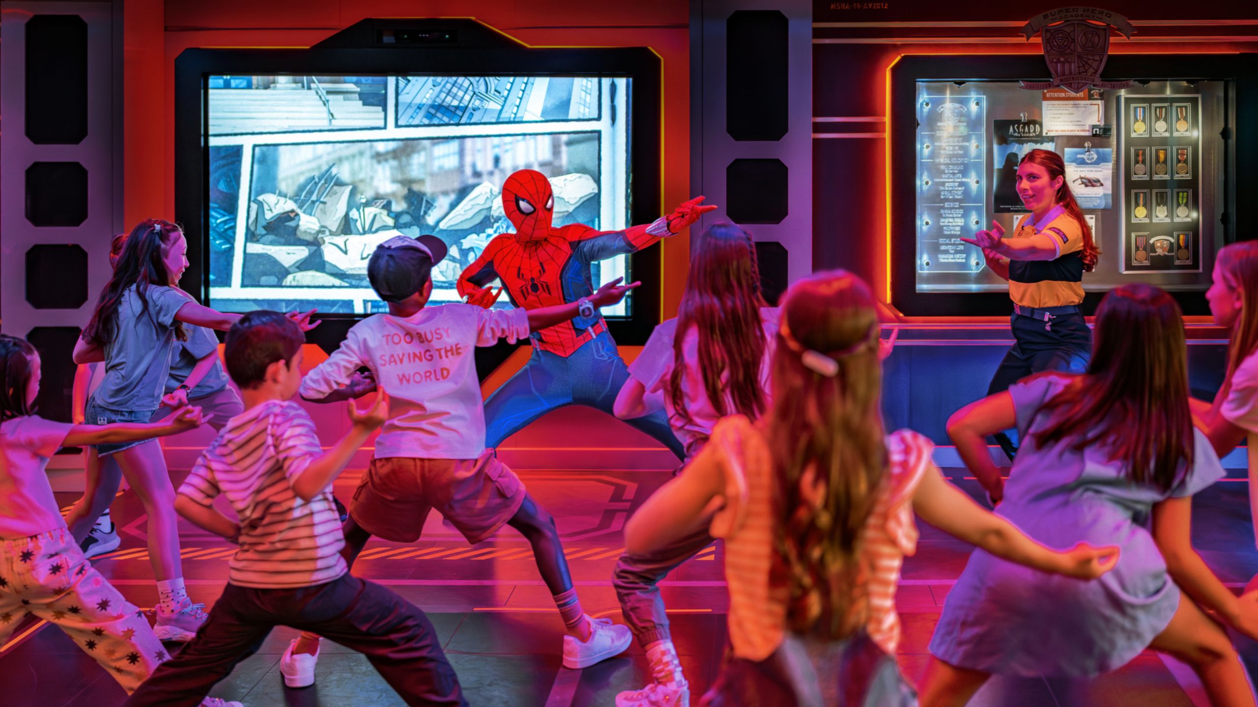 Young Guests interact with Spider Man in a room with Marvel décor