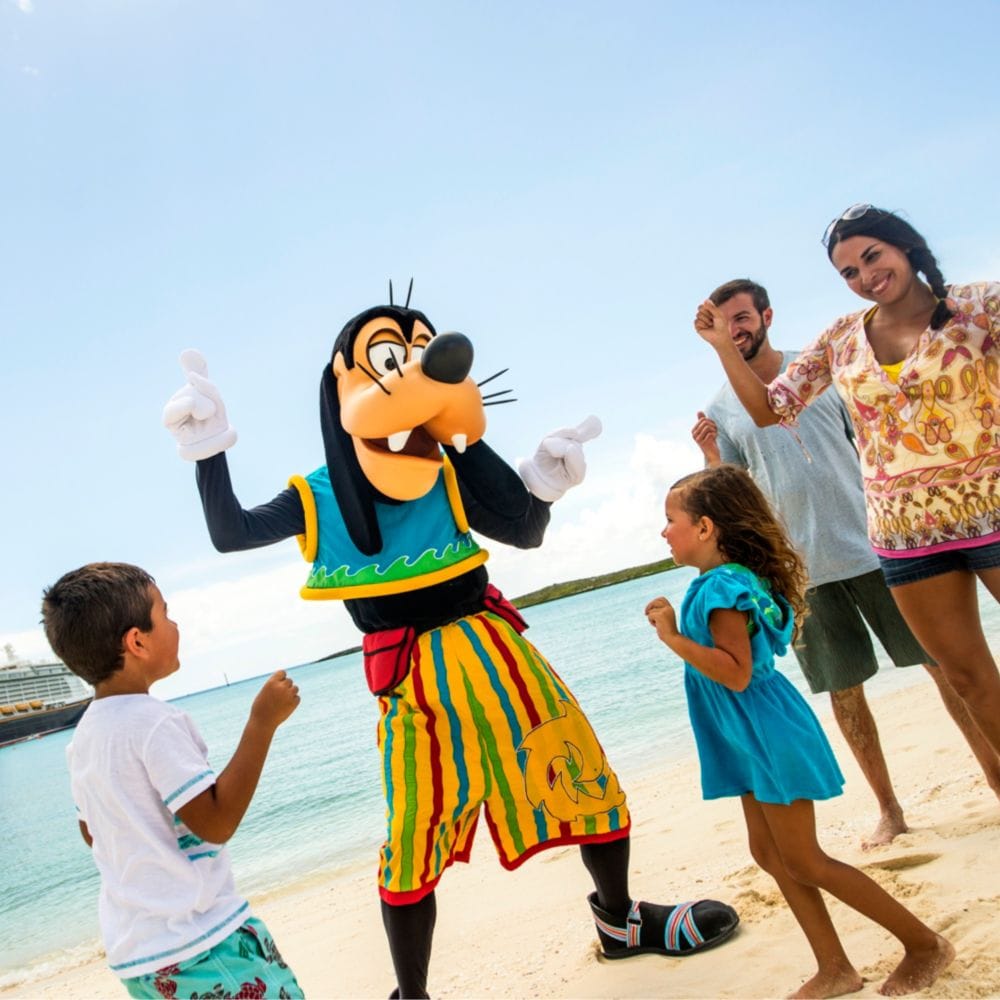 Goofy dancing with a family on a beach