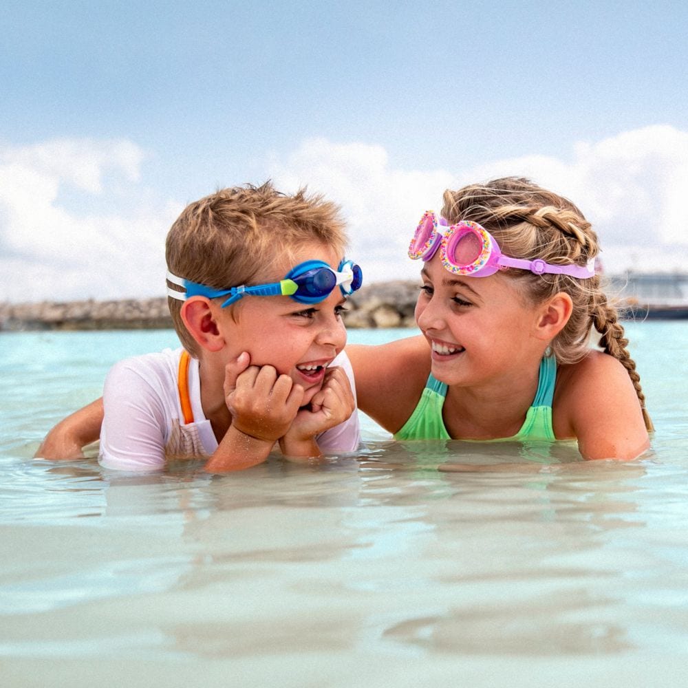 A boy and girl looking at each other while in the water