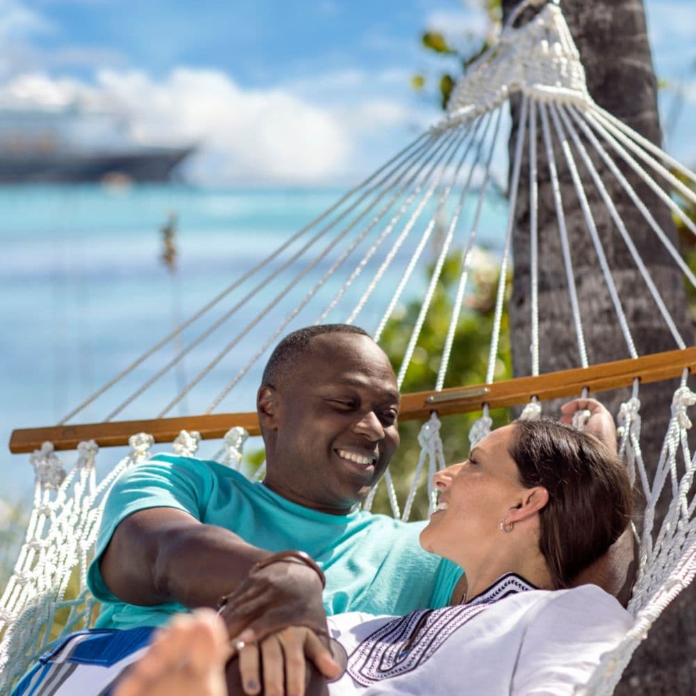 A man and woman lying together in a hammock