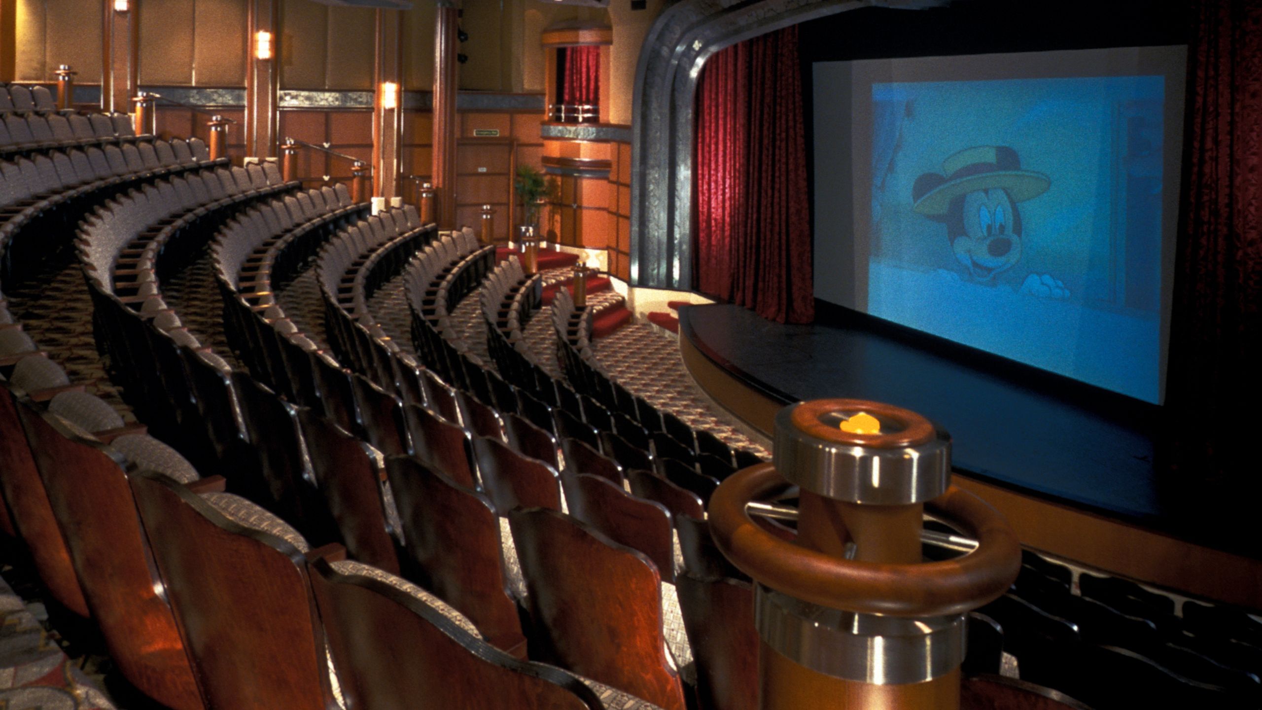 The Walt Disney Theatre with Mickey Mouse in a boater hat on the screen