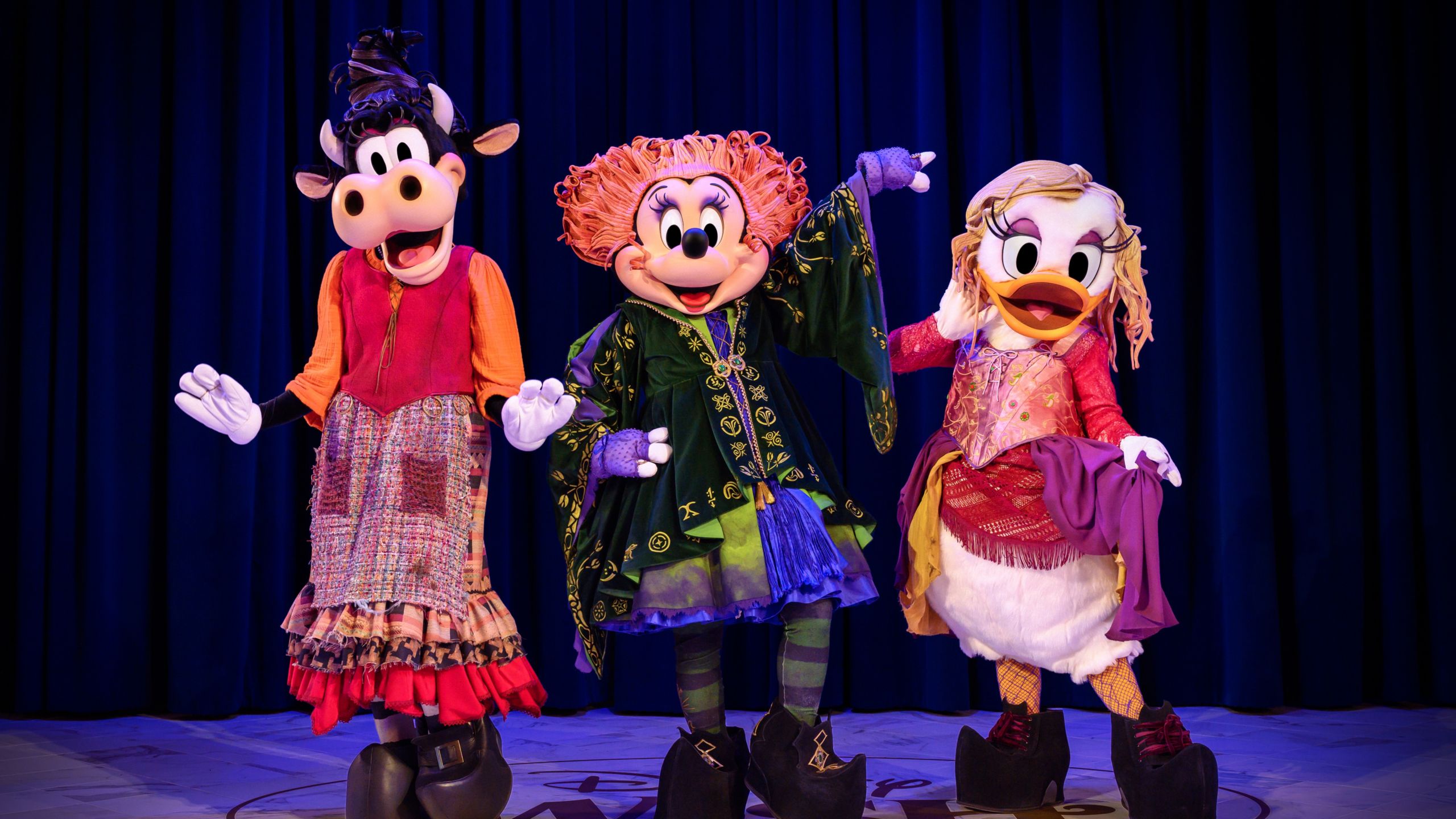 Minnie Mouse, Daisy Duck and Clarabell Cow dressed as the Sanderson Sisters from the Disney film Hocus Pocus