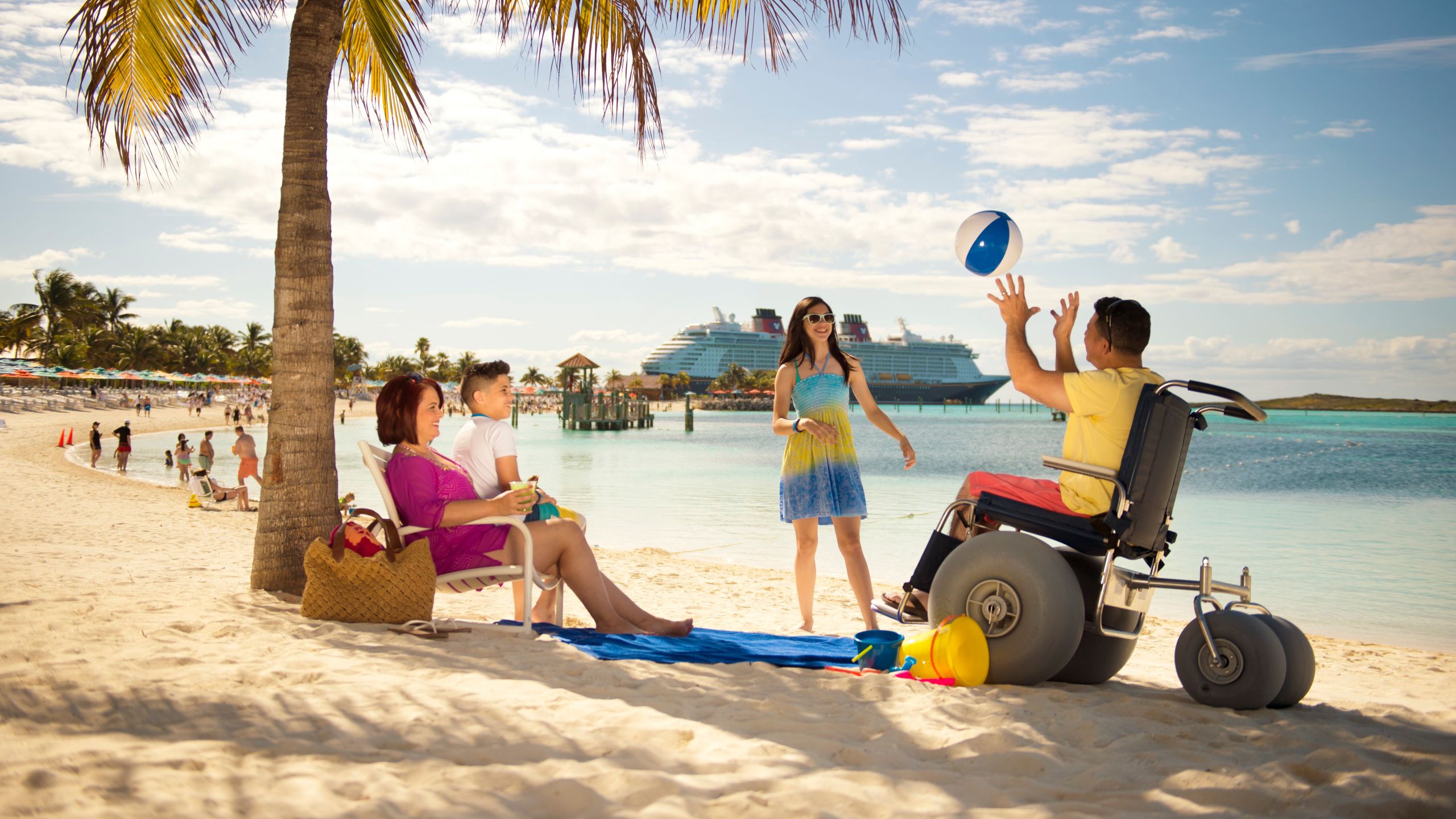 A family of 3, one of them in a wheelchair, relaxing on a beach, with text below that says, 'Special Services'