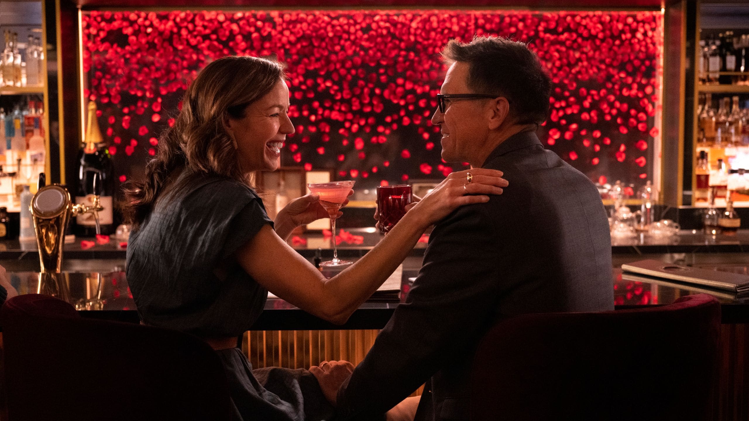 A couple drinking cocktails at The Rose lounge on board the Disney Destiny ship