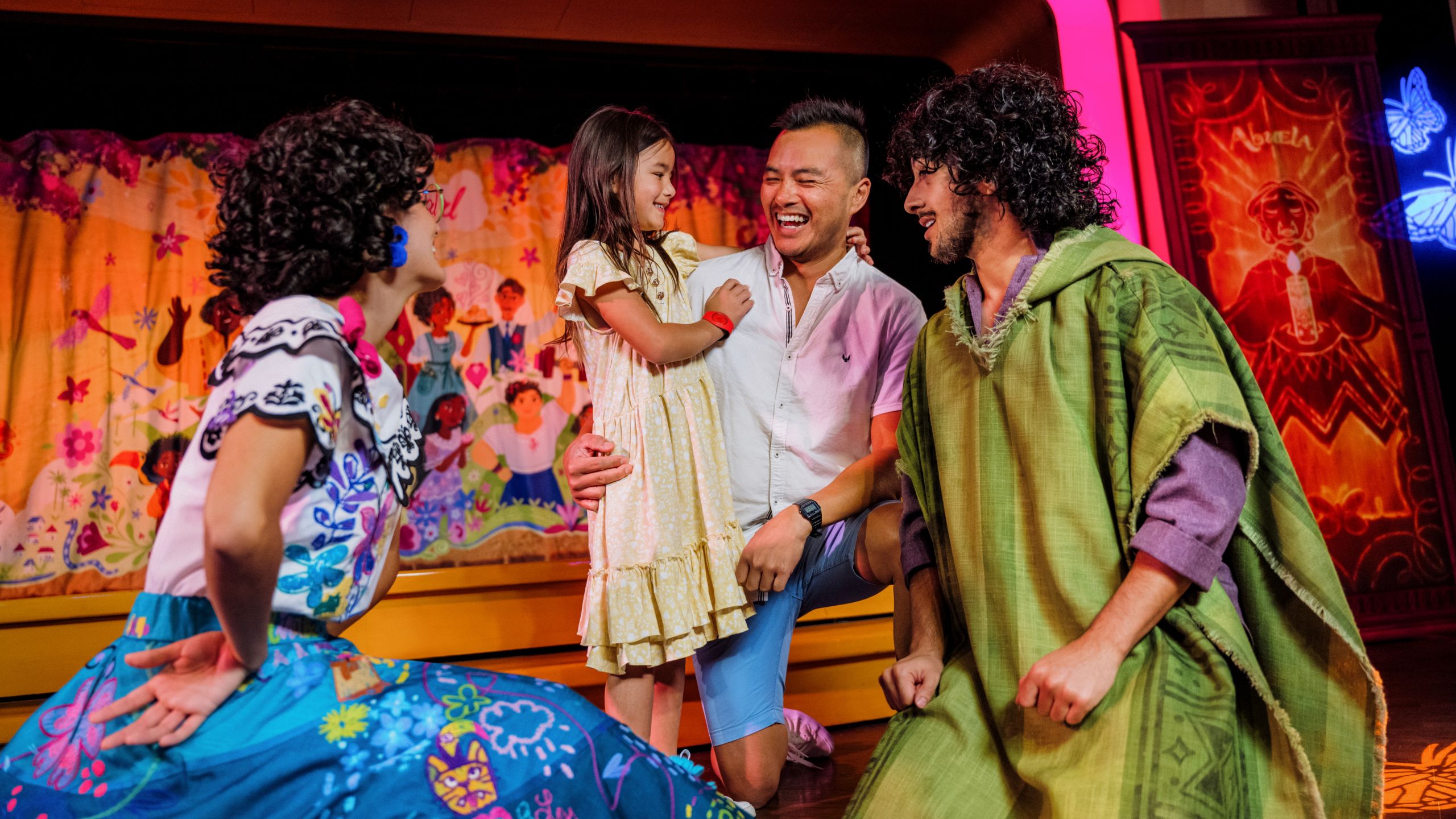 Maribel and Camilo from Encanto greeting a father and daughter 