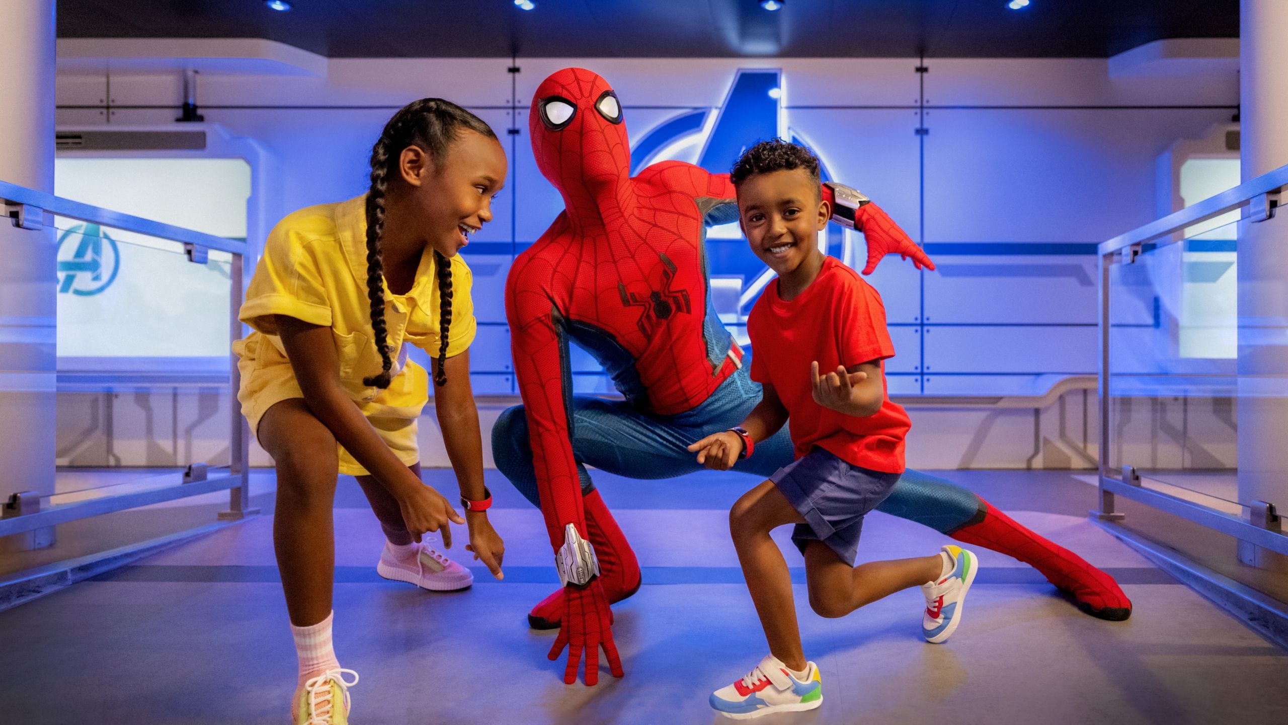 Duas crianças sorriem e posam com o Homem-Aranha